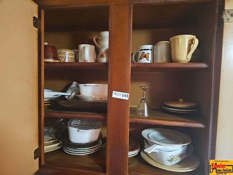 Selection of various kitchen items including mugs, plates, bowls, glassware, and assorted serving dishes. Some items are stackable. image