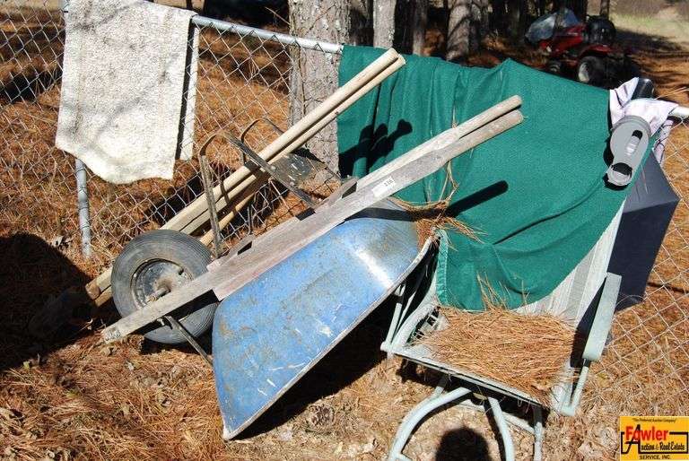 Wheelbarrow, Lawn Chair and Post Hole Digger image