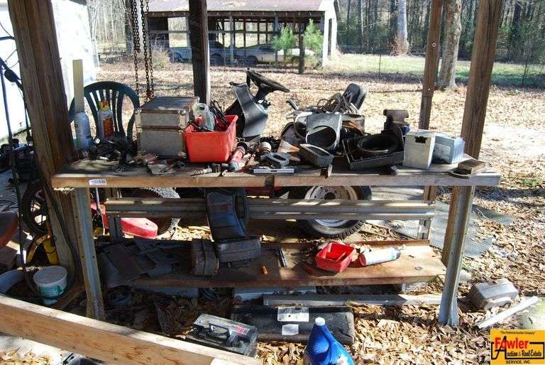 Workbench with Lawn Mower Parts and Tools image