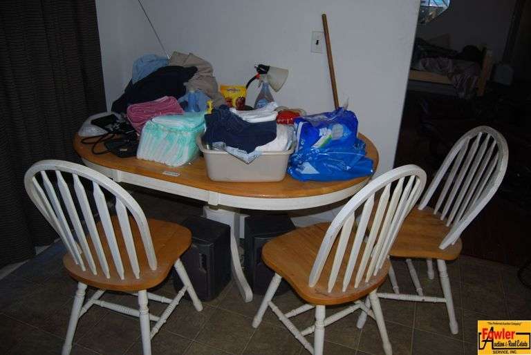 Round Dining Table with Three Chairs and Assorted Household Items image