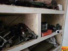 Shelving Unit Contents Including Assorted Parts, Tools, and Oil