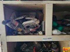 Shelving Unit Contents Including Assorted Parts, Tools, and Oil