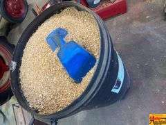 Husqvarna Brute Rolling Container with Wood Shavings