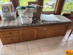 Storage Cabinet with Cushioned Seat & Contents on top