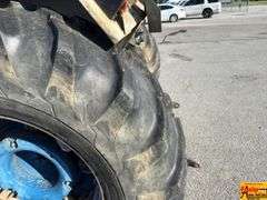 Ford 7000 Tractor with Woods DuAl loader & hay fork attachment. 3,355 hrs.  Runs good.  See video.