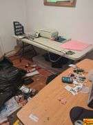 Contents Of Room:  display case, folding tables, printer, display monitor with mouse