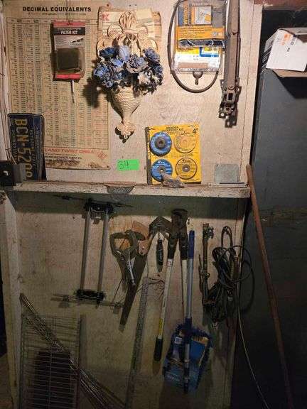Contents on Wall Including Saw, Drag Light, and Clamp image