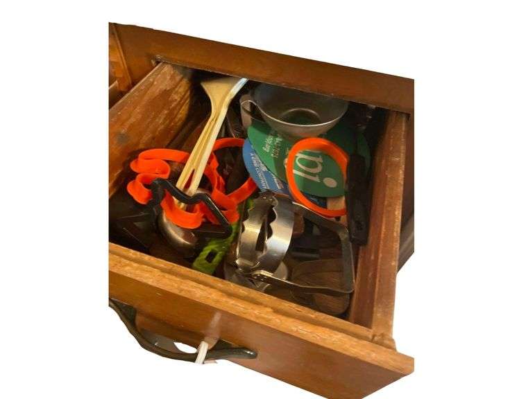 Contents in Upper Drawer and Lower Cabinet - Stock Pot with Cookie Cutters - Grater - Strainer image