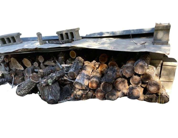 2 Stacks of Wood on Side of Garage image