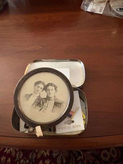 assortment of pins and vintage photo in oval frame image