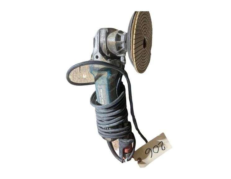An Electric Makita Angle Grinder with Plenty of Buffing and grinding Pads image