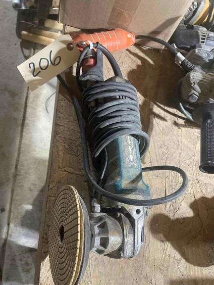 An Electric Makita Angle Grinder with Plenty of Buffing and grinding Pads image