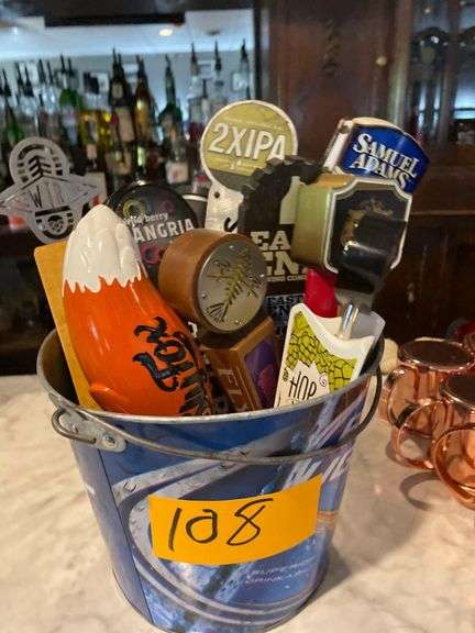 Approximately 8 Beer Taps in a Budweiser Bucket