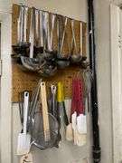 Utensiels on Wall along with Fan and Box of Cling Wrap