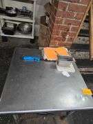 Metal Table with Lower Shelf. 30 in. Square x 29 in. H. Contents Included
