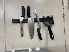 Utensiels on Wall along with Fan and Box of Cling Wrap