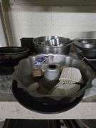 Plastic Shelf and Contents Including Large Metal Bowls, Large Colander, Fry Pans, Muffin Tins, Plastic Food Buckets. Shelf 63 in. T x 36 in. W x 17 in. D