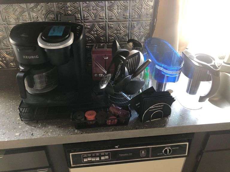 Contents of Counter Including Keurig, Bread Toaster, Euro-Pro Toaster Oven, Drying Rack, Kitchen Utencils, Water Filtration Pitchers