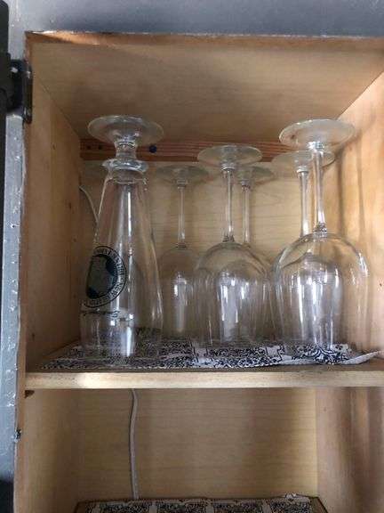 All Contents of Cupbards Including Metal Utencils, Glass Mugs, Glass Plates and Bowls, Plastic Spoons, Cleaning Rags, Wine Glasses, Kitchen Utencils, Plastic Bags, Broom and Dustpan