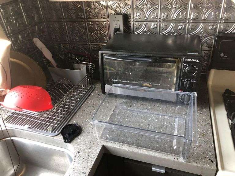 Contents of Counter Including Keurig, Bread Toaster, Euro-Pro Toaster Oven, Drying Rack, Kitchen Utencils, Water Filtration Pitchers