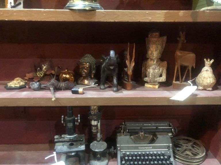 Various Decorative Items Including Faux Flower, Skull Wall Piece, Stick Dummy, 2 Head Figurines, Elephant Statue, 2 Antelope Statues, Golden Pumpkin, and Bird with Crown Statue