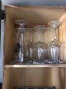 All Contents of Cupbards Including Metal Utencils, Glass Mugs, Glass Plates and Bowls, Plastic Spoons, Cleaning Rags, Wine Glasses, Kitchen Utencils, Plastic Bags, Broom and Dustpan