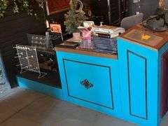 Wooden Counter/Display LShaped 8ft. L. X 8ft. L. X 21in. W. X Different Heights- Contents Not Included- Must Bring Proper Tools & Manpower For Removal