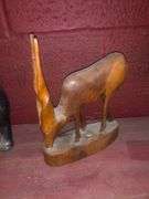 Various Decorative Items Including Faux Flower, Skull Wall Piece, Stick Dummy, 2 Head Figurines, Elephant Statue, 2 Antelope Statues, Golden Pumpkin, and Bird with Crown Statue
