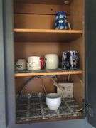 All Contents of Cupbards Including Metal Utencils, Glass Mugs, Glass Plates and Bowls, Plastic Spoons, Cleaning Rags, Wine Glasses, Kitchen Utencils, Plastic Bags, Broom and Dustpan