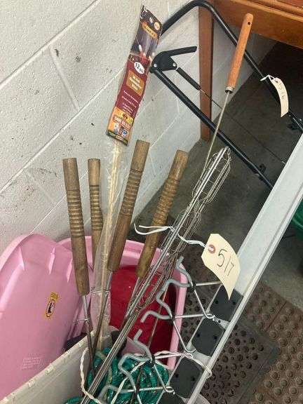 Bin with Various Outdoor Items Including Sleeping Bag, Battery Lamps, Hot Dog Sticks, Marshmallow Sticks, Burger Cookers, and Rope image