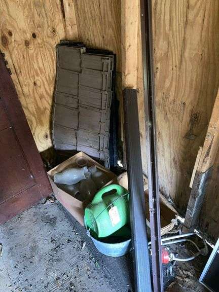 Contents in Corner Including Metal Pail, Plastic Watering Can, and Skirting/Siding image
