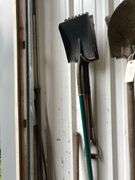Contents of Wall Including Shovels, Brooms, Spud Bars, Pickax, and Rakes