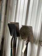 Contents of Wall Including Shovels, Brooms, Spud Bars, Pickax, and Rakes