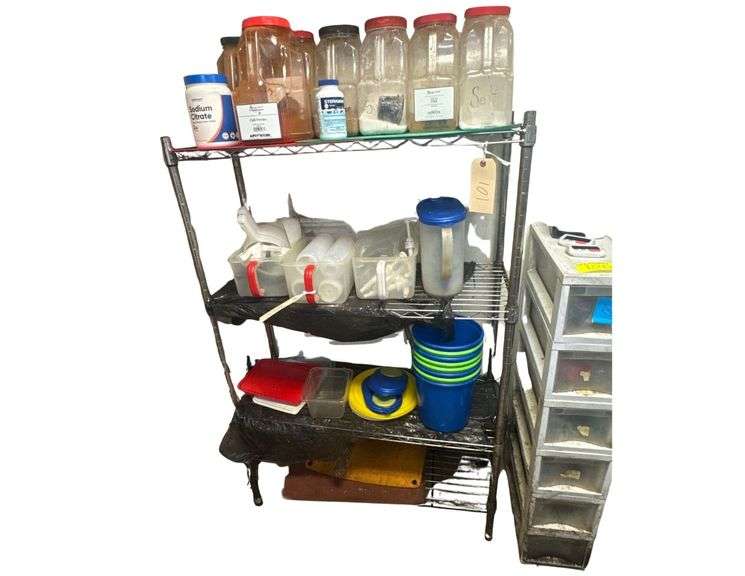 Contents of Shelf Including Spices, Plastic Containers, Scoops, and Dispenser Bottles image