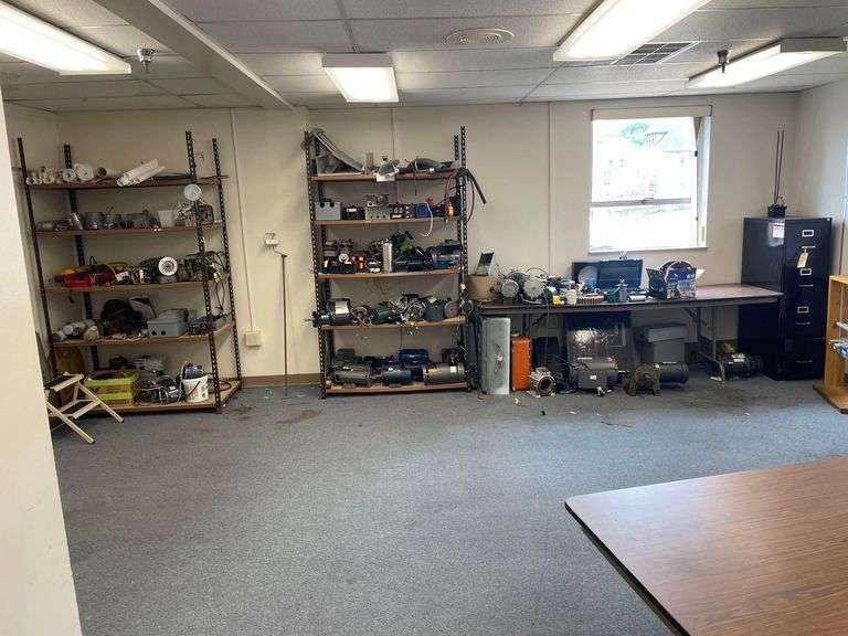 2 Shelfs 48x24x84 Inches Full of Electrical Motors an 8 Foot Long Table with More Motors and a Filing Cabinet image