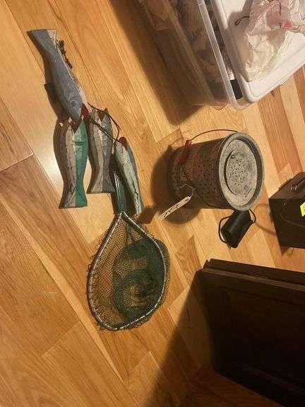 A Minnow Bucket a Fishing Net with a String of 4 Wooden Fish image