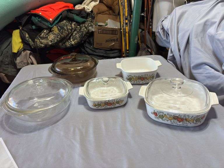 Three spice of life casserole dishes and two Pyrex serving dishes