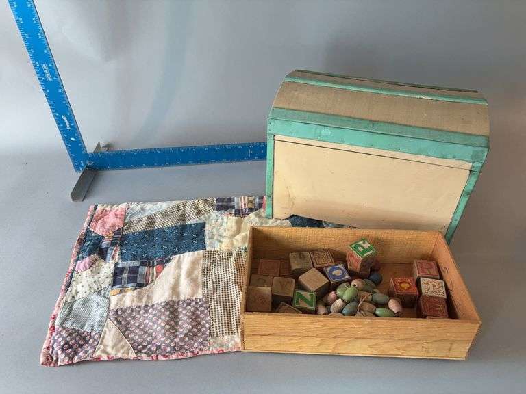 Small doll trunk 8x13x9H with wooden alphabet blocks, wooden beads and quilt piece image