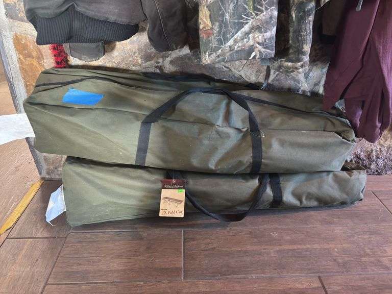 Macho outdoors - two oversized camp cots. One brand new, one used one with a partial tear image