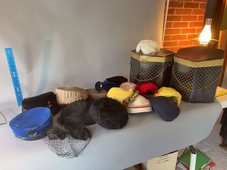 Two hat boxes and hats as shown image