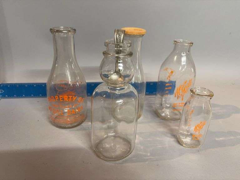 Milk bottles, some local and a cream spoon image
