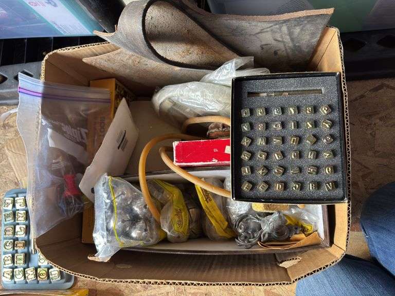 Small set of leather letter and number stamps plus assorted leather working items, including bells, drawer pulls, snaps