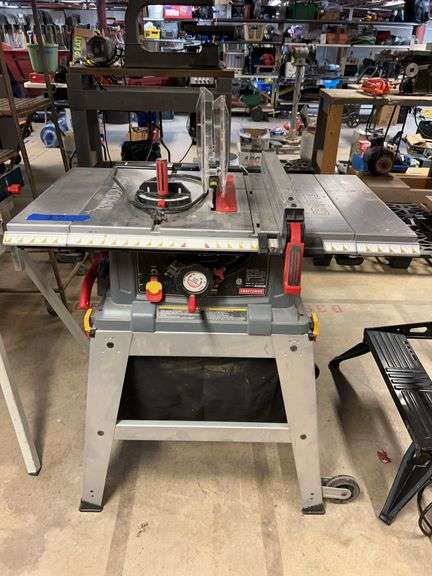 Craftsman 10-in table saw, with dust collection bag, laser track and base with wheels. image