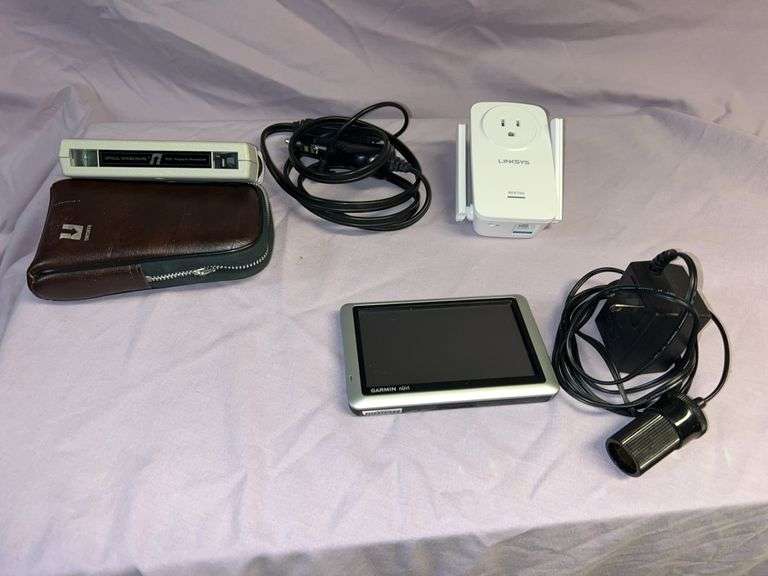 Miscellaneous lot consisting of Linksys range extender re6700. Garmin Nuvi 1450 with cigarette adapter cable. Optical tape measure. M100 AC to 12 volt DC power supply with adapter. image