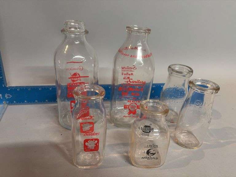 Various brand and size milk bottles image