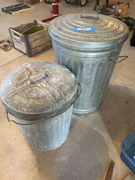 Two galvanized trash cans