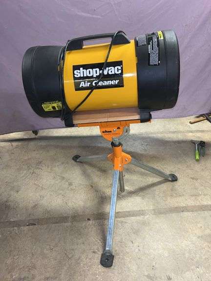 Shop-Vac air cleaner model AC235A no filter. Triton multi-stand. Four double wheel casters fixed 3-in wheels 220 lb capacity. Green bench 37 in w x  12-in d x 14-1/2 in h. Black& Decker 3/8 drill with many drill bits, sanding pads and driver bits. image