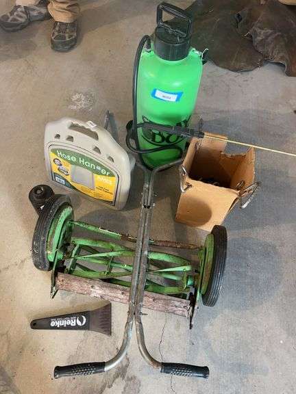 Antique push mower, sprayer, hose hanger, dog stakes