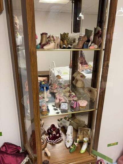 Top 3 shelves of curio includes mini shoes and purses, etc image