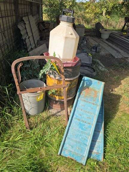 Blue car ramps, chicken waterer, hay harpoon fork and barrel